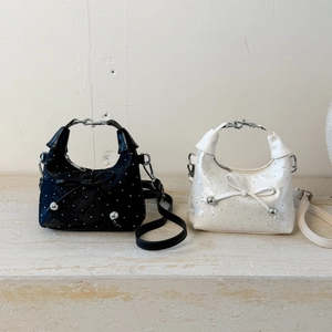 Sac seau minimaliste noir et blanc avec détail nœud et poignées métalliques