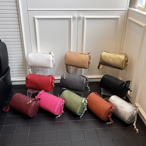 Woven leather cylinder crossbody bags in eleven vibrant colors for a stylish commute