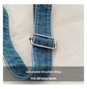 Detail of adjustable denim shoulder strap with durable silver metal rectangle buckle