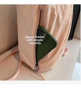 Detail view of pink nylon backpack featuring a secure back anti-theft zipper pocket