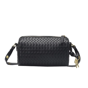 Minimalist black woven leather barrel crossbody bag with gold hardware and knot detail