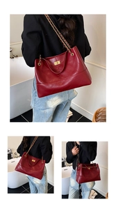 Close-up of quilted burgundy tote bag with gold chain strap and metal turn-lock detail