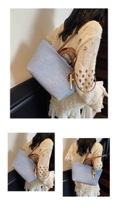 Close-up of a blue denim tote bag with leather straps and decorative wooden beads