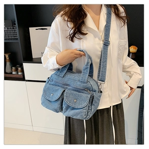 Lifestyle shot of denim crossbody bag with contrast stitching and metal snap pockets