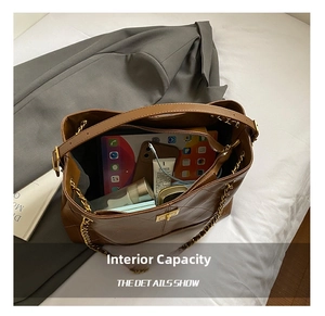 Top view of spacious brown quilted bag interior showing main compartment and zipped pocket