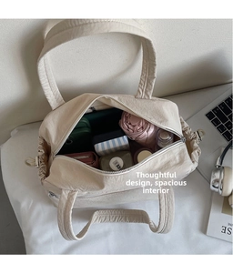 Detail view of large interior storage capacity of the beige pleated canvas tote bag