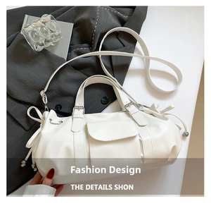 Close-up of cream white soft leather travel bag with flap pocket and drawstring details