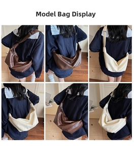 Detail view of large capacity PU leather dumpling bag with wide strap in brown and beige