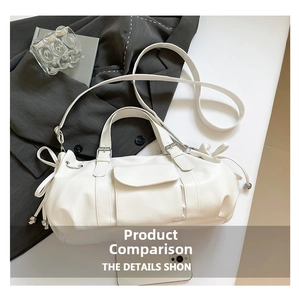 Detail of white Boston bag with bow accents, lychee texture, and adjustable strap