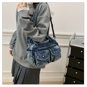 Retro washed denim crossbody bag featuring multi-pocket utility design and wide shoulder strap