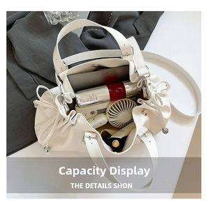 Top view of large capacity white leather Boston bag showing tablet and cosmetics inside