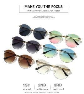 Detailed view of frameless ocean tint sunglasses featuring gold leopard head hinge hardware