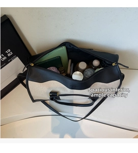 Top view of spacious interior of canvas travel bag containing tablet and water bottle