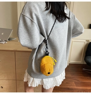 Detailed back view of a yellow mini hat-shaped crossbody bag with black adjustable strap
