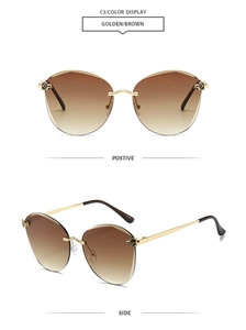 Detail of golden leopard head ornament on frameless brown gradient lens sunglasses