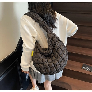 Detail of quilted puffer cloud bag showing the soft texture and fashion woven label