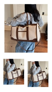 Detail of canvas travel bag with leather handles and reinforced metal buckles