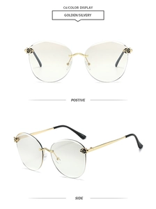 Detail of rimless sunglasses featuring golden metal hinges with a decorative panther head motif
