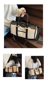 Detail of canvas travel bag with leather handles and detachable shoulder strap