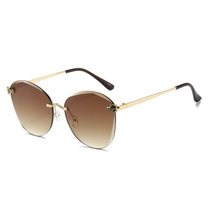 Frameless brown gradient sunglasses with gold metal frame and panther head decoration