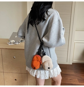 Detail of creative mini baseball cap crossbody bag with woven strap and plastic hook