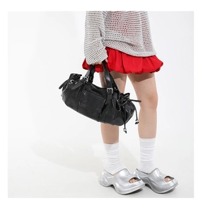 Detail of black pleated leather bag with silver metallic bead drawstring decoration