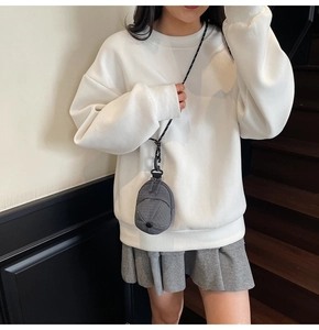 Close-up of a creative grey baseball cap shaped mini crossbody bag with plaid texture