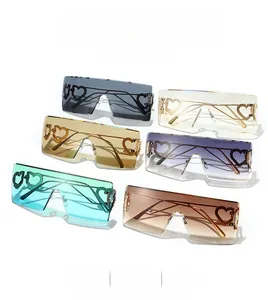 Close-up of frameless square sunglasses with hollow heart-shaped metal temple hinges