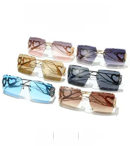 Detail of rimless heart sunglasses with gold metal temples and gradient lenses
