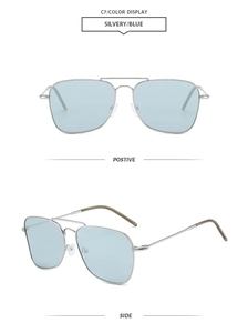 Detail view of silver metal pilot sunglasses with light blue translucent lenses