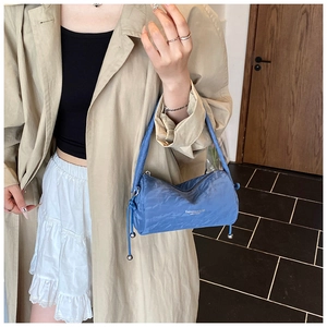 Blue pleated shoulder bag with silver ball charms and FASHION & BAGS text on nylon