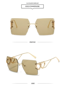 Detail view of gold metal heart ornaments on rimless champagne square sunglasses