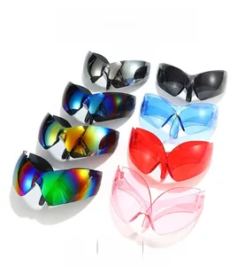 Flat lay of futuristic wrap-around sunglasses in various vibrant colors and chrome finishes