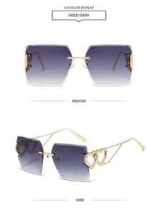 Detail of rimless square sunglasses with gold metal hinges and heart-shaped cutouts