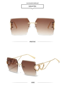 Detail view of gold metal temples with heart cutouts and tea gradient rimless lenses
