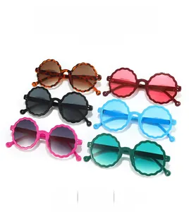 Detailed flat lay of round wave-frame kids sunglasses in six vibrant various colors