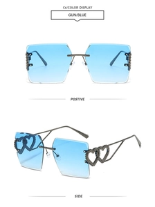 Detail view of rimless heart-shaped gradient blue sunglasses with gunmetal heart accents