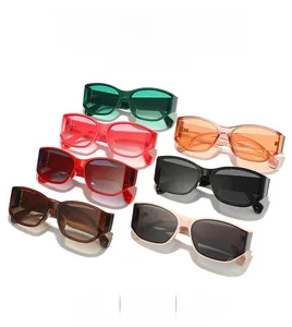 Detail view of stylish square sunglasses in green, pink, orange, and multiple colors