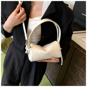 Detailed shot of white marble pattern barrel bag with silver zipper and leather strap