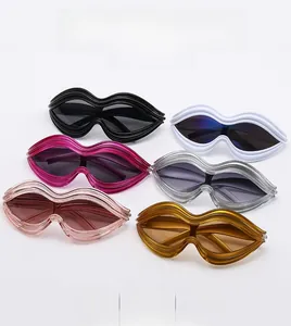 Detailed view of fashionable lip-shaped sunglasses in six vibrant colors on white background