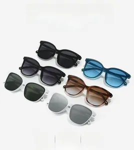 Flat lay of multiple retro cat-eye sunglasses with gradient lenses and vibrant frame colors