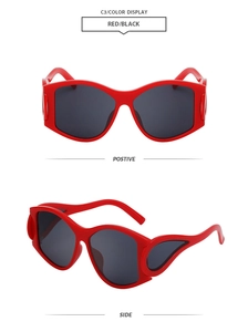 Detail view of red oval punk sunglasses with unique flame-like hollow streamline temples