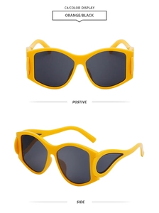 Macro detail of oval orange frames with distinctive wing design on side temples