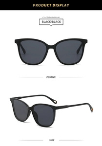 Detail of cat-eye sunglasses with black frame and golden teardrop cutout on temples