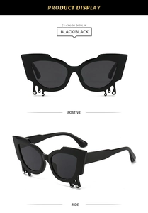 Close-up of black cat-eye sunglasses with unique silver liquid teardrop rhinestone details