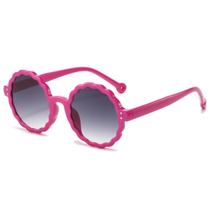 Pink petal-shaped round frame kids sunglasses with grey gradient lenses and UV protection