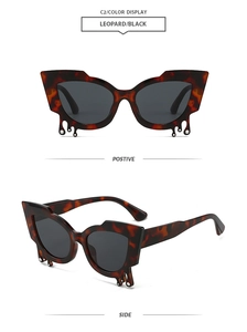 Detail of leopard print cat eye sunglasses with rhinestone teardrop accents and dark lenses