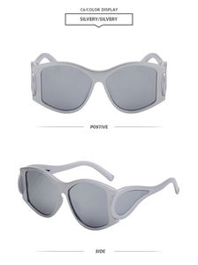 Detail view of silver oval oversized sunglasses with side wing design and metallic finish