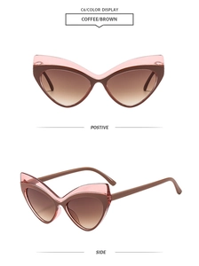 Détail de lunettes de soleil œil de chat rose et marron avec verres dégradés tendance