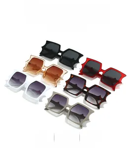 Detailed view of oversized cat-ear sunglasses in black, brown, red, and tortoise shell frames